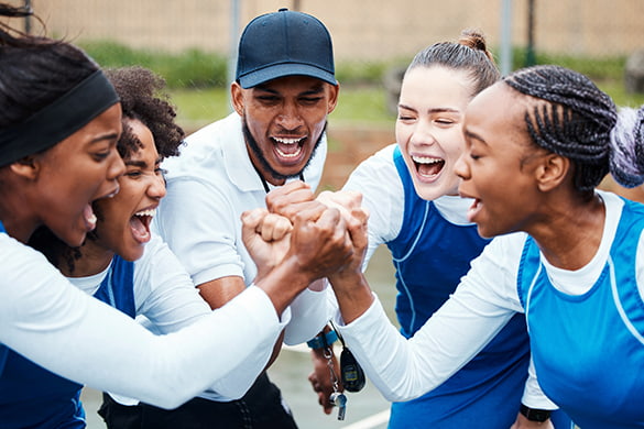 A girl's sports team celebrates a victory