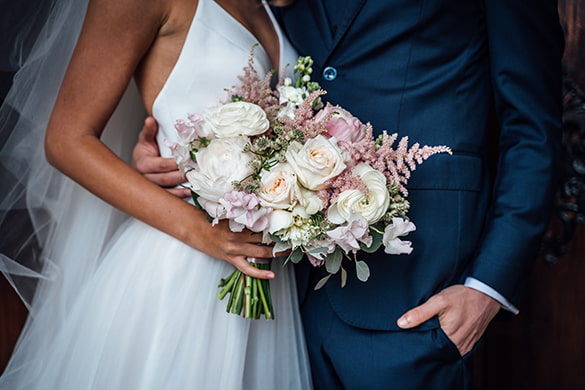 a bride and groom embrace on their wedding day