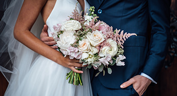 a bride and groom embrace on their wedding day