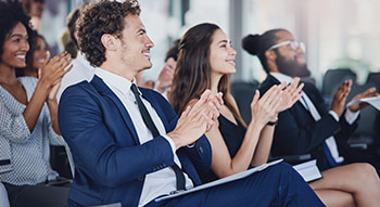 conference attendees clap after a presentation